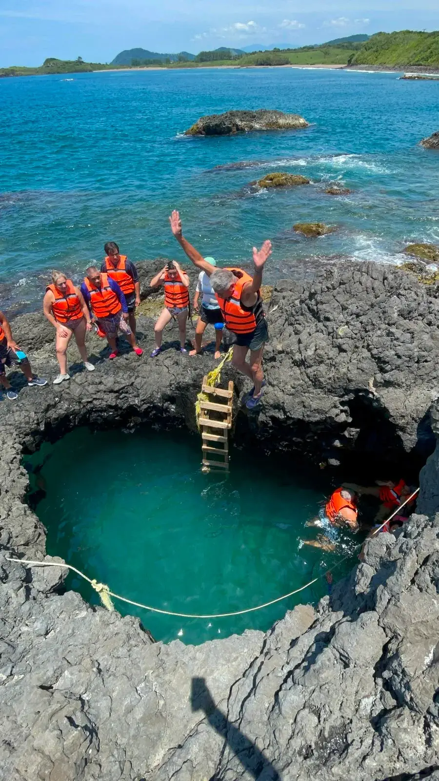 Visitante a punto de aventarse un clavado a la poza de roca volcánica de Playa Ermita, en la costa de Los Tuxtlas, Veracruz